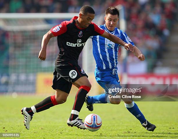 Liam Feeney of Bournemouth is tracked by Marcos Painter of Brighton & Hove Albion during the npower League One match between Brighton & Hove Albion...