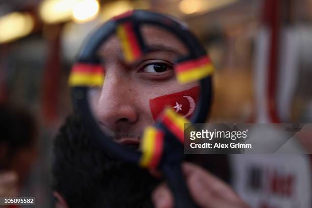 Supporters get their faces painted at the bus of the 'Fanclub der Nationalmannschaft' before the EURO 2012 group A qualifier match between Germany...
