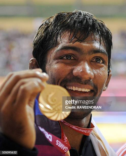 India's gold medalist Yogeshwar Dutt poses at the awards ceremony for 60kg men's freestye wrestling at the Commonwealth Games 2010 in New Delhi on...