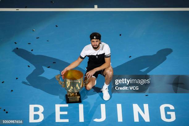 Nikoloz Basilashvili of Georgia poses with the trophy after winning the Men's Singles final match against Juan Martin del Potro of Argentina on day...