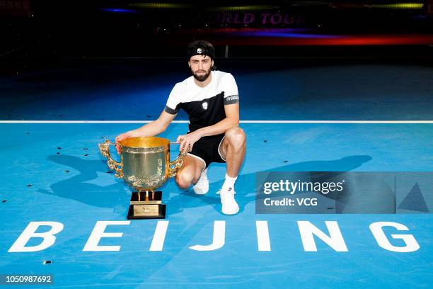 Nikoloz Basilashvili of Georgia poses with the trophy after winning the Men's Singles final match against Juan Martin del Potro of Argentina on day...