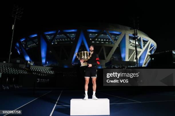 Nikoloz Basilashvili of Georgia poses with the trophy after winning the Men's Singles final match against Juan Martin del Potro of Argentina on day...