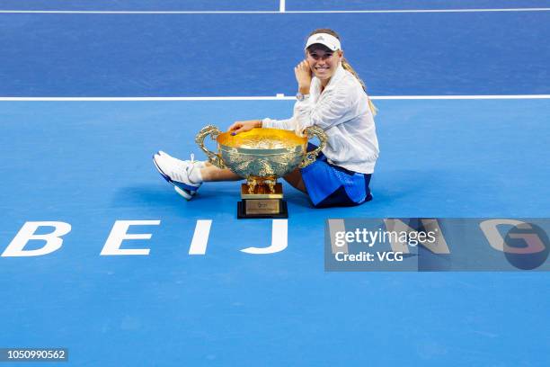 Caroline Wozniacki of Denmark poses with the trophy after winning the Women's Singles final match against Anastasija Sevastova of Latvia on day nine...