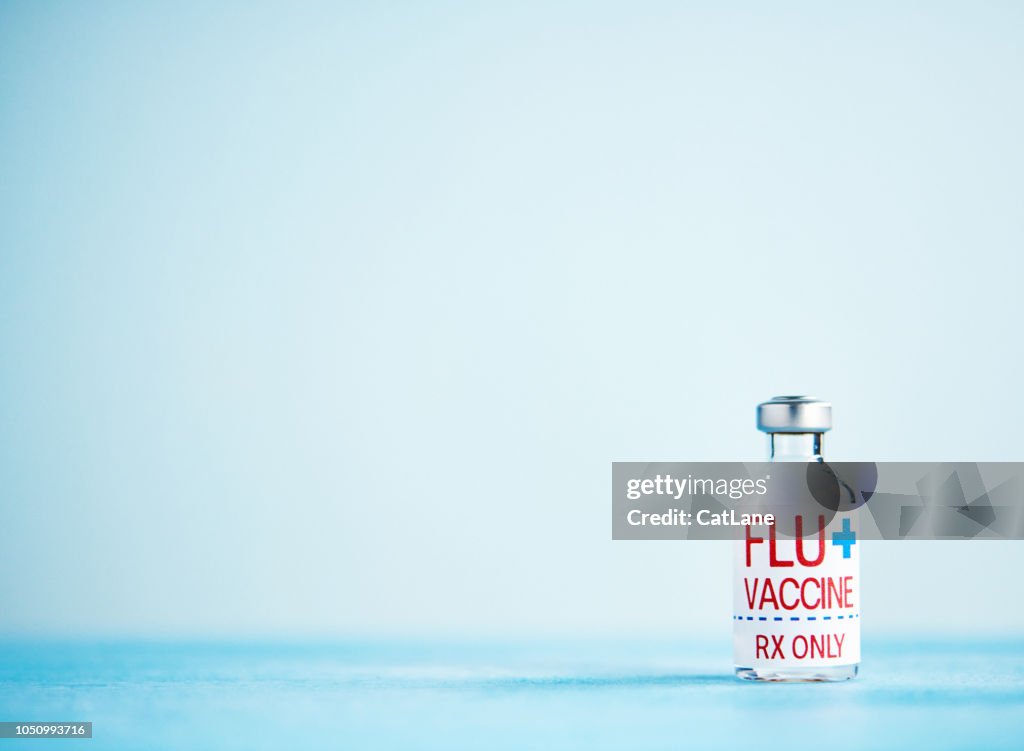 Vial with flu vaccine and copy space