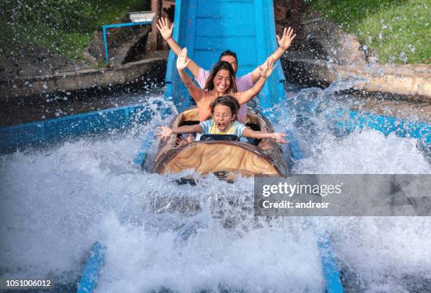 happy family having fun in an amusement park - theme park imagens e fotografias de stock