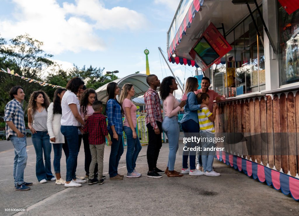 Happy people buying food at an amusement park