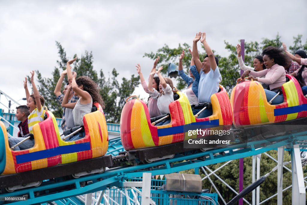 Happy group of people having fun in an amusement park