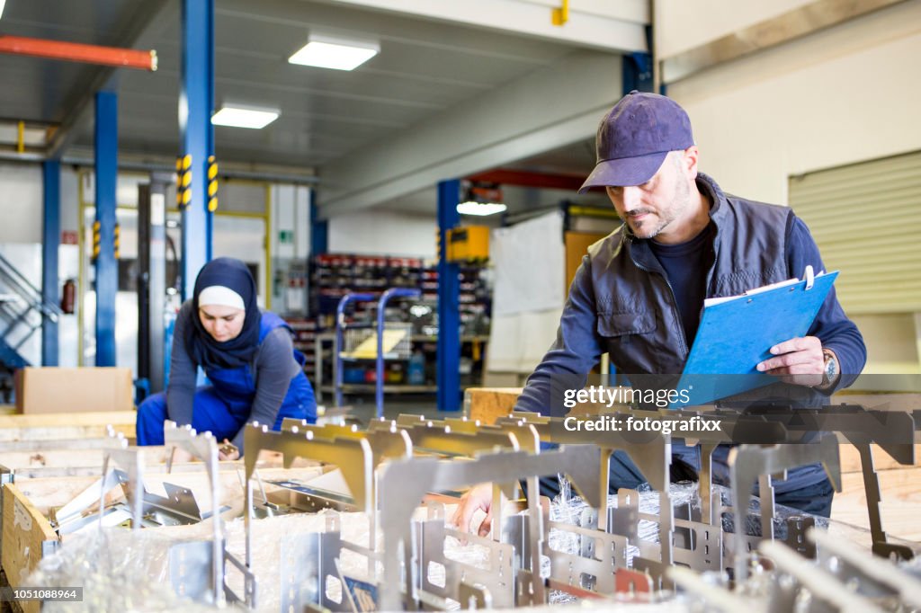 Technician team make a quality control of metal pieces in a Metal manufacturing company