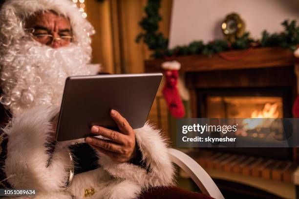 nahaufnahme von santa clause mit digital-tablette am heiligabend. - santa close up stock-fotos und bilder