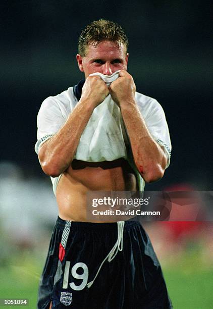 Paul Gascoigne of England lifts his shirt to his face as he celebrates after the 1990 FIFA World Cup quarter final match between England and Cameroon...