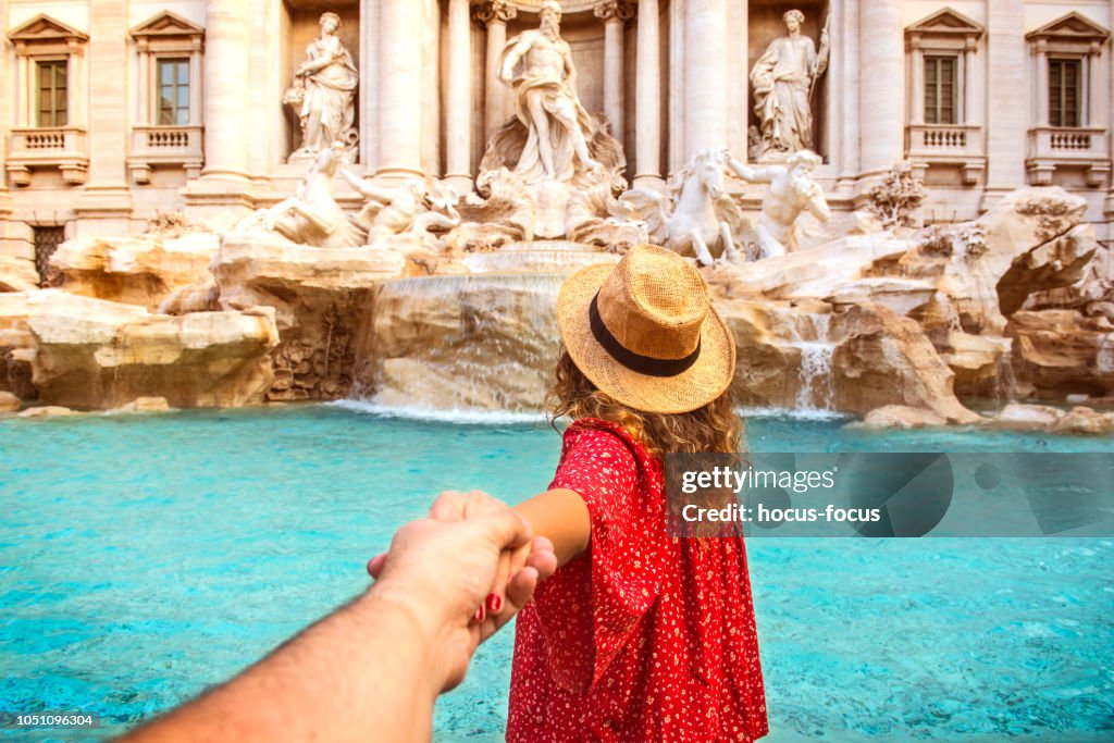 Couple of tourist on vacation in front of Trevi Fountain Italy