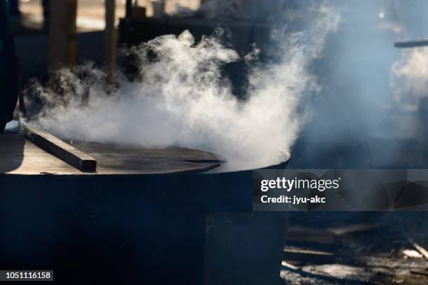 at the festival, i am making big broth with big iron pot. - stew pot foto e immagini stock