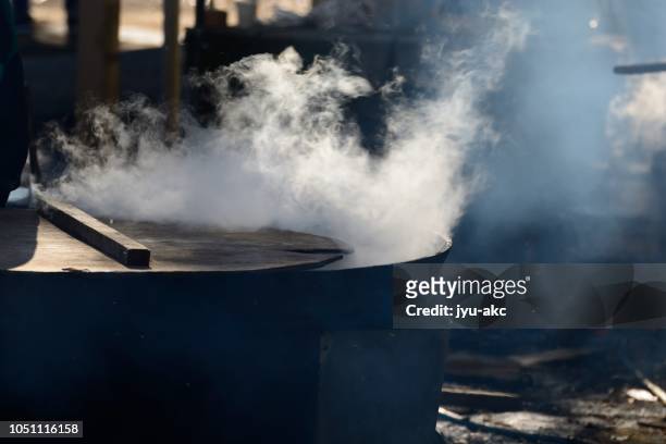 at the festival, i am making big broth with big iron pot. - boiling steam stock pictures, royalty-free photos & images