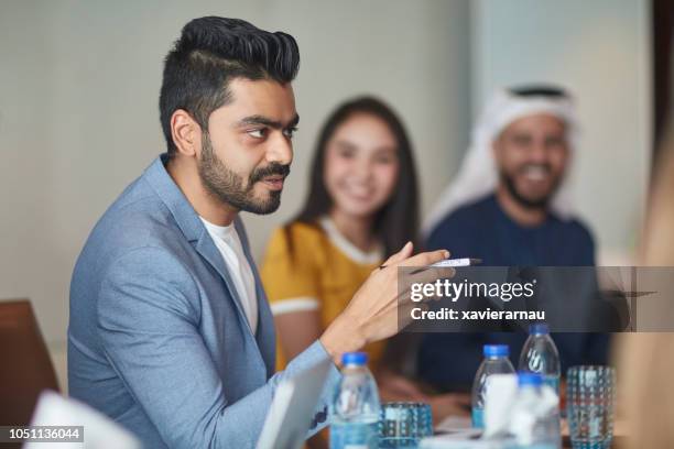 indian businessman discussing in board room - abu dhabi business stock pictures, royalty-free photos & images