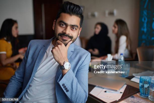 confident businessman sitting in board room - blue blazer stock pictures, royalty-free photos & images