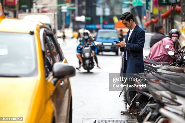 business man asking for directions and waiting for a taxi in the city downtown - hail stock pictures, royalty-free photos & images