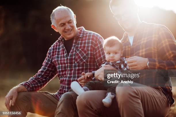 three generations male bonding in nature - grandson stock pictures, royalty-free photos & images