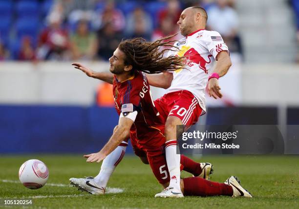 Kyle Beckerman of Real Salt Lake is tripped up by Joel Lindpere of the New York Red Bulls fighting for the ball on October 9, 2010 at Red Bull Arena...