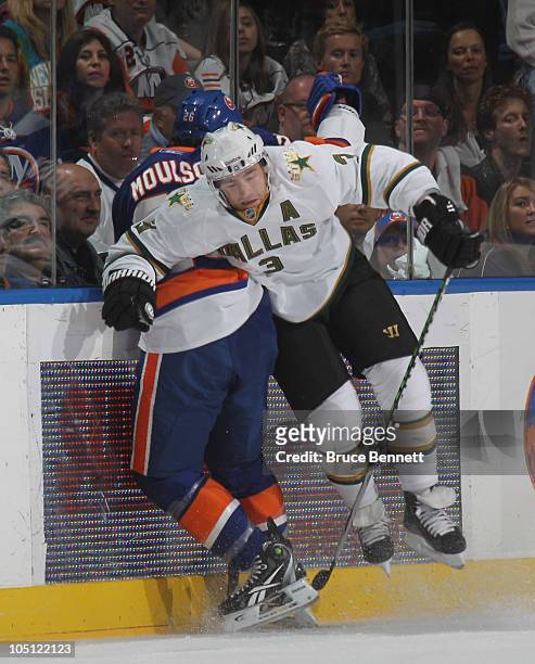 Stephane Robidas of the Dallas Stars hist Matt Moulson of the New York Islanders at the Nassau Coliseum on October 9, 2010 in Uniondale, New York.
