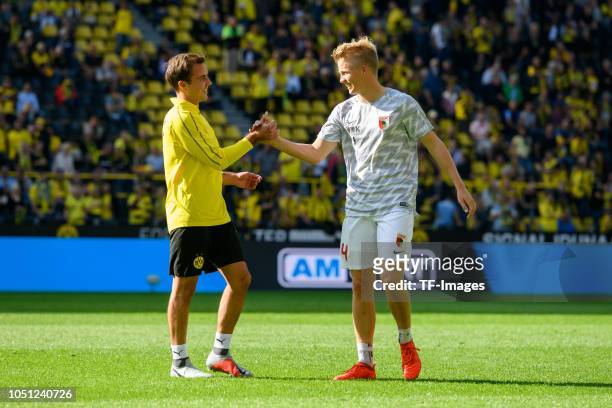 Mario Goetze of Borussia Dortmund shakes hands with his brother Felix Goetze of FC Augsburg during the Bundesliga match between Borussia Dortmund and...