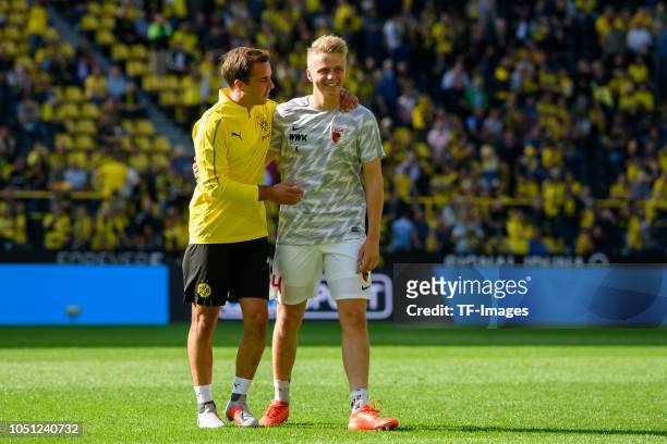 Mario Goetze of Borussia Dortmund and his brother Felix Goetze of FC Augsburg laugh during the Bundesliga match between Borussia Dortmund and FC...