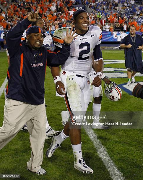 An Auburn fan signaled 6 for the number of touchdowns scored by quarterback Cam Newton as the Tigers defeated Kentucky, 37-34, at Commonwealth...