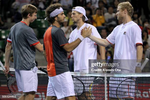 Eric Butorac of the United States and Jean-Julien Roger of the Netherlands Antilles shake hands with Andreas Seppi of Italy and Dmitry Tursunov of...