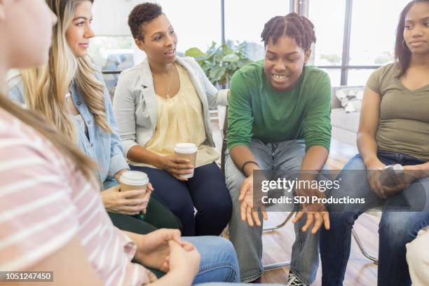 teenage boy shares with support group - group women support doctor stock pictures, royalty-free photos & images