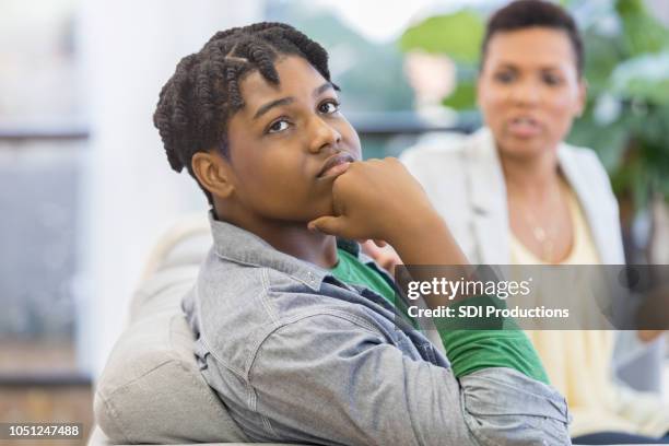 teenage boy ignores lecturing mother at home - teen fight stock pictures, royalty-free photos & images