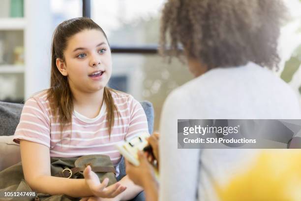 teenage girl talks to school counselor - psychotherapy stock pictures, royalty-free photos & images