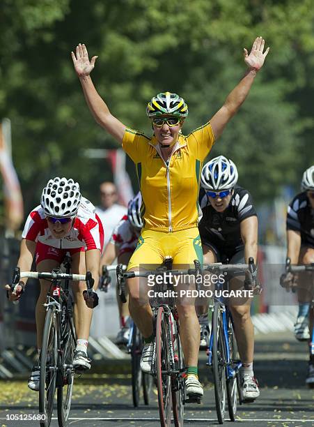 Australia's Rochelle Gilmore crosses the finishing line first in the Women's 112km Road Race Cycling event in New Delhi on October 10, 2010....