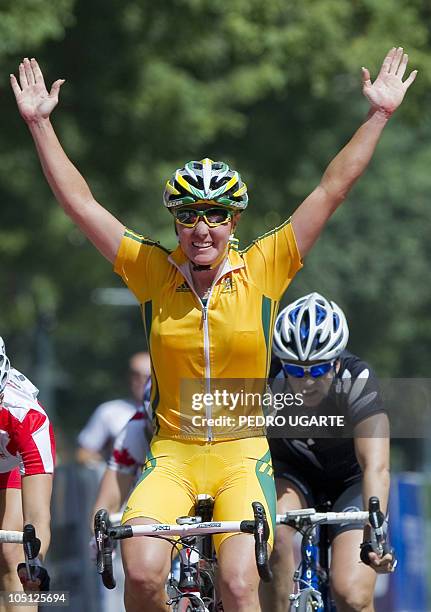 Australia's Rochelle Gilmore crosses the finishing line first in the Women's 112km Road Race Cycling event in New Delhi on October 10, 2010....