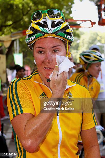 Rochelle Gilmore of Australia wipes her face after finishing the Women's Road Race in first place and wins the gold medal during day seven of the...