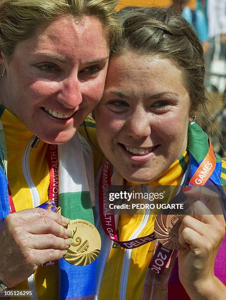 Australia's Rochelle Gilmore and Chloe Hosking show their gold and bronze medals at the Women's 112km Road Race Cycling awards ceremony in New Delhi...