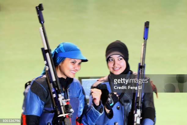 Bronze medalist Nur Suryani Mohamed Taibi and Silver medalist Nur Ayuni Halim pose after the Womens 10m air rifle singles event at the Dr Karni Singh...