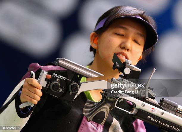 Xiang Wei Jasmine celebrates winning gold during the Womens 10m air rifle singles event at the Dr Karni Singh Shooting Range during day seven of the...