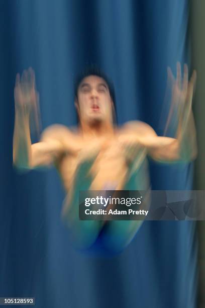 Alexandre Despatie of Canada competes in the Men's 1m Springboard Final at the Dr. S.P. Mukherjee Aquatics Complex during day seven of the Delhi 2010...