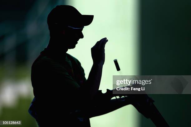 Robert John Auerbach of Trinidad and Tobago completes in the Men's Singles Trap final at the Dr Karni Singh Shooting Range during day seven of the...