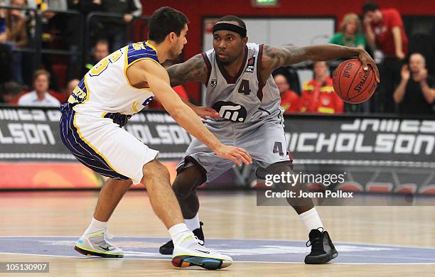 Tyrese Rice of Quakenbrueck and Nemanja Protic of Oldenburg battle for the ball during the Basketball Bundesliga match between Artland Dragons and...