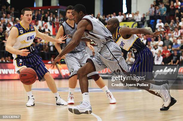 Bryan Bailey of Quakenbrueck and Rickey Paulding of Oldenburg battle for the ball during the Basketball Bundesliga match between Artland Dragons and...