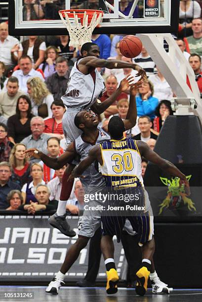 Bryan Bailey and Domonic Jones of Quakenbrueck and Steven Smith of Oldenburg battle for the ball during the Basketball Bundesliga match between...