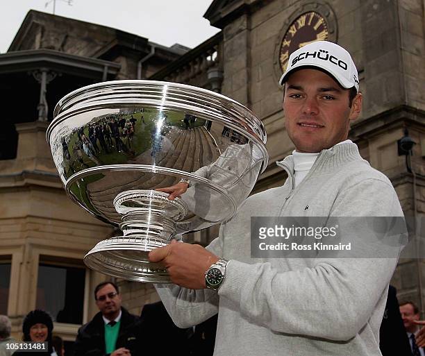 Martin Kaymer of Germany holds the trophy in front of the clubhouse after his victory in the final round of The Alfred Dunhill Links Championship at...