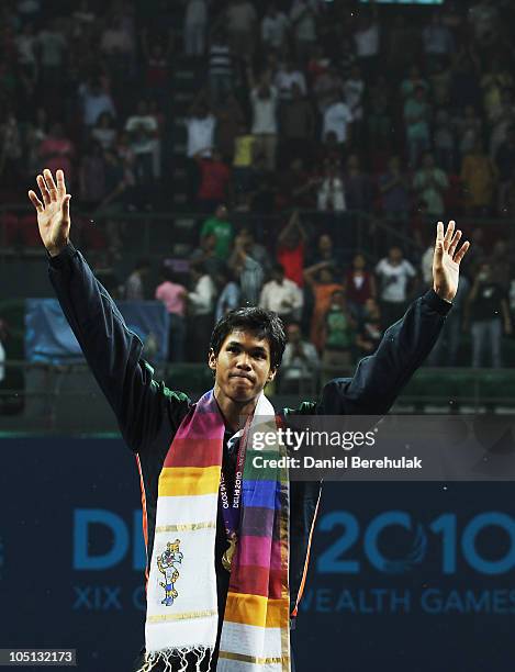 Gold medal winner Somdev Devvarman of India celebrates during the medal ceremony for the men's singles event at RK Khanna Tennis Stadium during day...