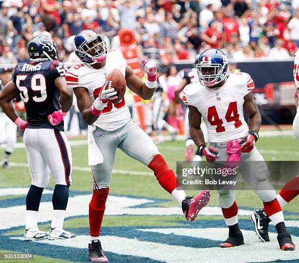 Wide receiver Hakeem Nicks celebrates with Ahmad Bradshaw after scoring on a passs in the second quarter at Reliant Stadium on October 10, 2010 in...