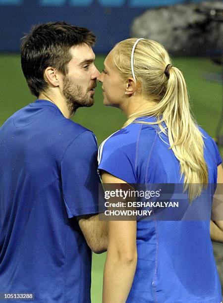 Scotland tennis players Colin Fleming and Jocelyn Rae greet each other after winning the tennis mixed doubles at the R.K. Khanna Stadium in New Delhi...