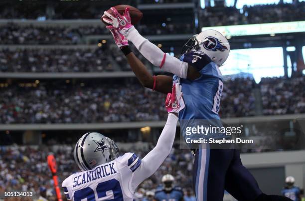 Wide receiver Nate Washiington of the Tennessee Titans jumps to catch a 24 yard touchdown pass over cornerback Orlando Scandrick of the Dallas...