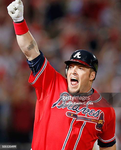 Eric Hinske of the Atlanta Braves reacts after hitting a two-run homer in the eighth inning off pitcher Sergio Romo of the San Francisco Giants...