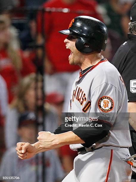 Freddy Sanchez of the San Francisco Giants celebrates after scoring the go-ahead run off an error by Brooks Conrad of the Atlanta Braves in the ninth...