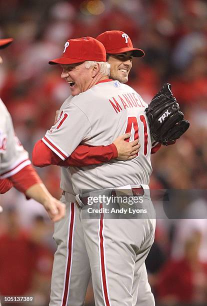 Manager Charlie Manuel of the Philadelphia Phillies hugs pitcher Cole Hamels following a complete game shut-out against the Cincinnati Reds during...