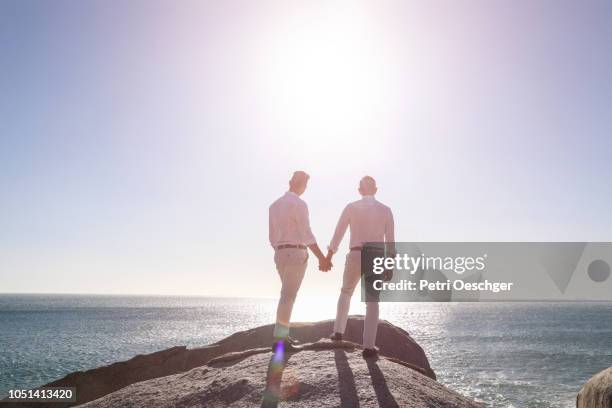 gay wedding by the sea. - civil partnership stock pictures, royalty-free photos & images